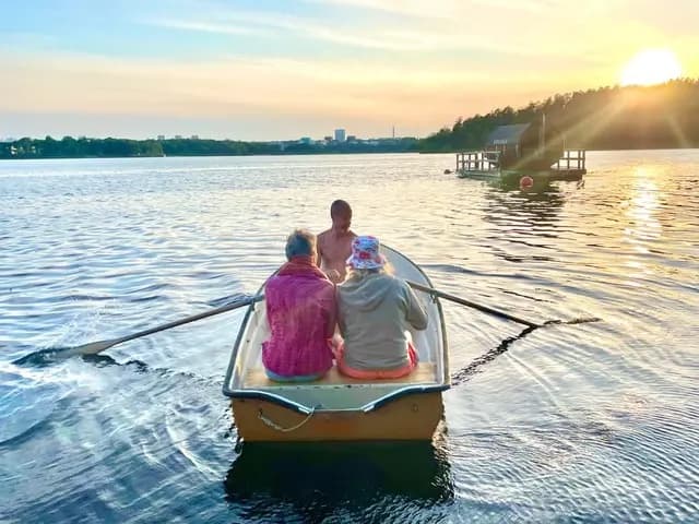 Two people rowing on the lake in evening sun